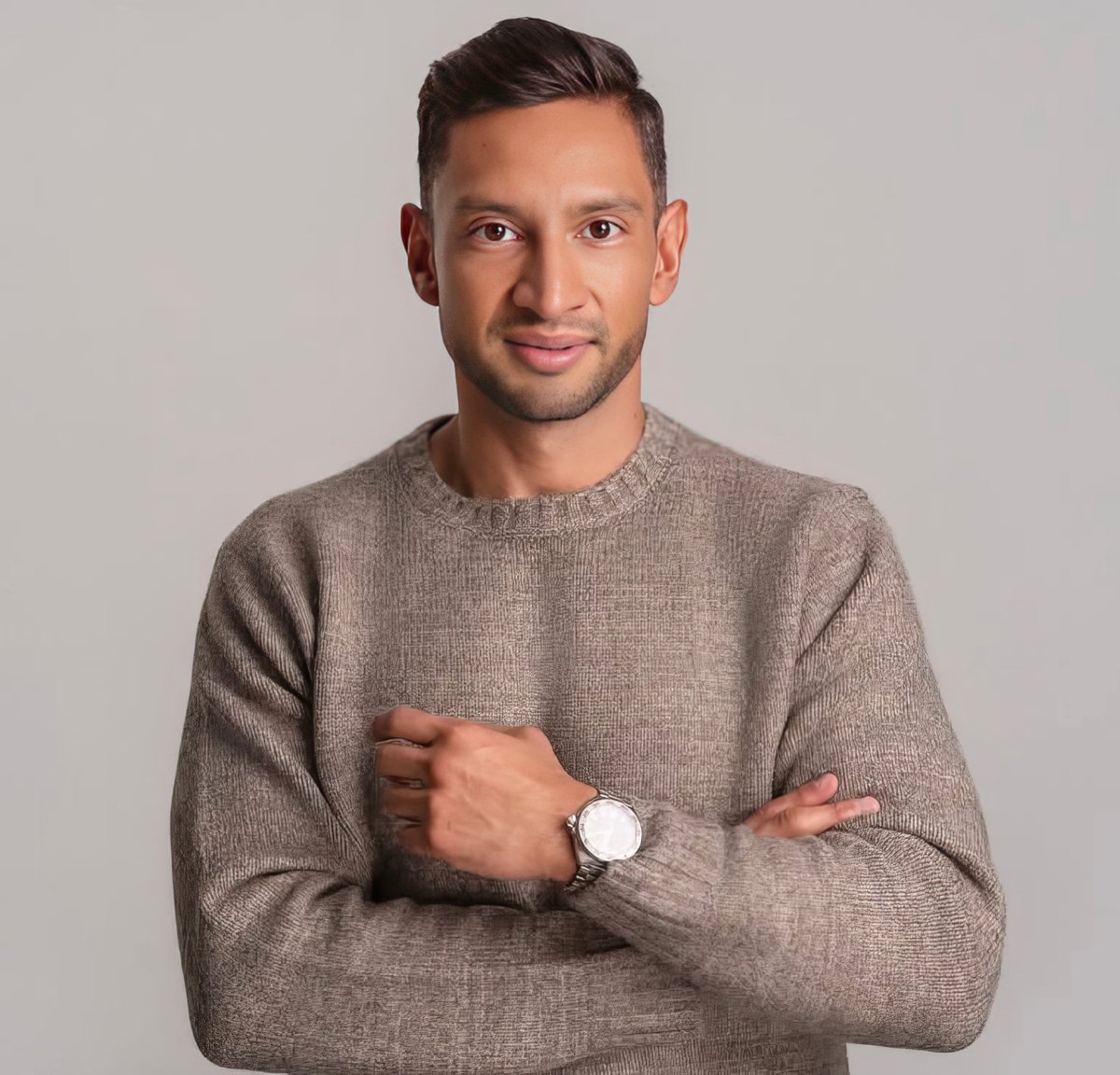 Professional headshot of a man in a gray sweater with arms crossed, shot by Media Home Tours
