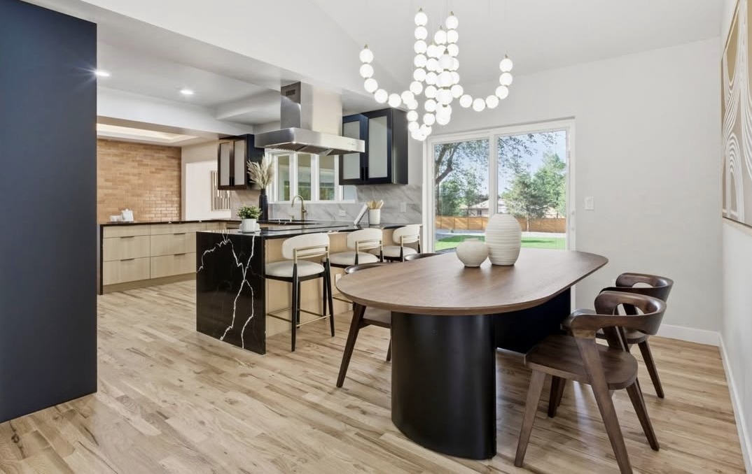 Dining area with a modern chandelier next to the kitchen