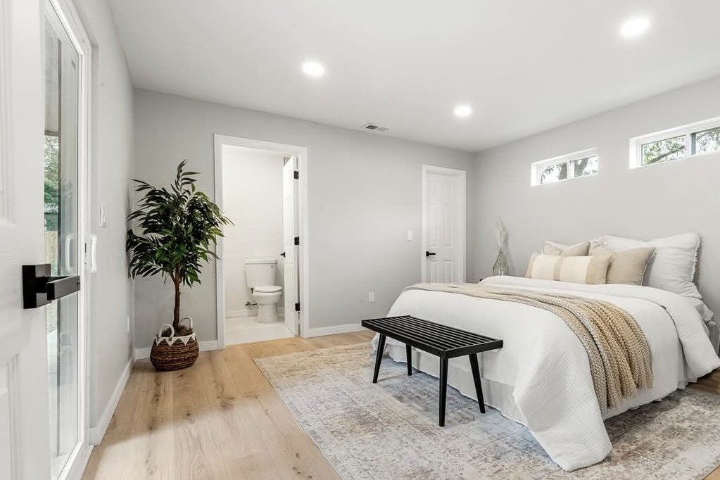 Bedroom with an ensuite bathroom and black bench