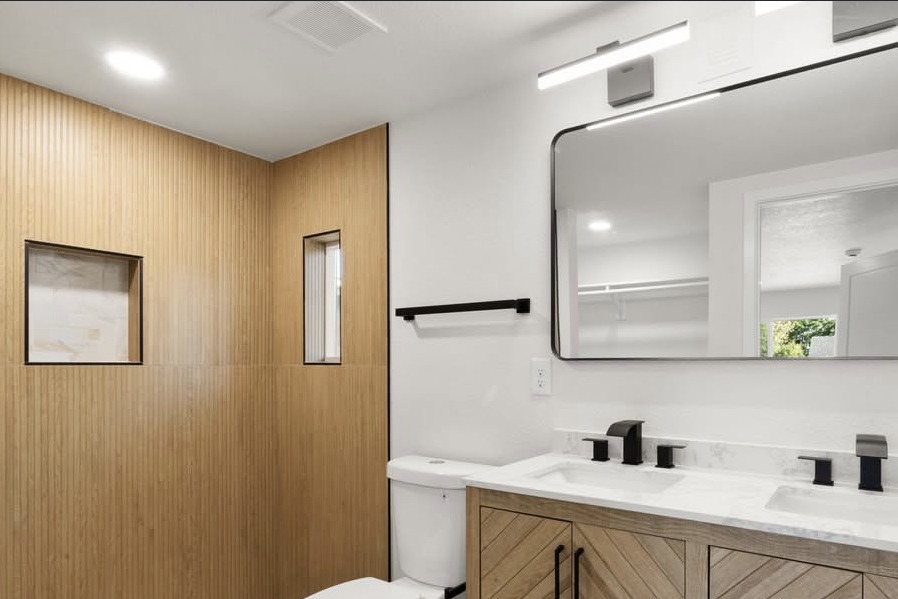 Bathroom with a wood slat wall and chevron vanity