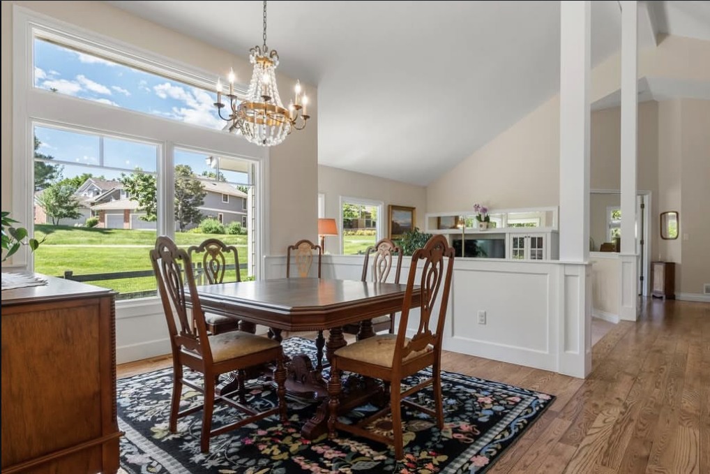 Formal dining room with a crystal chandelier and golf course view