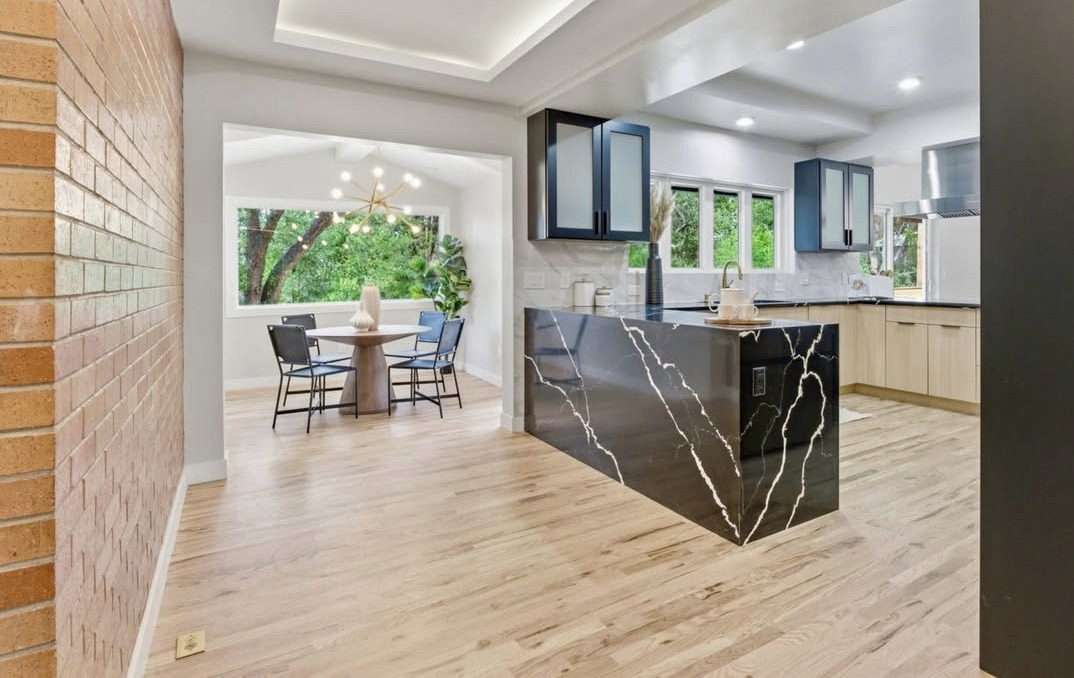 Kitchen and breakfast nook with a brick accent wall