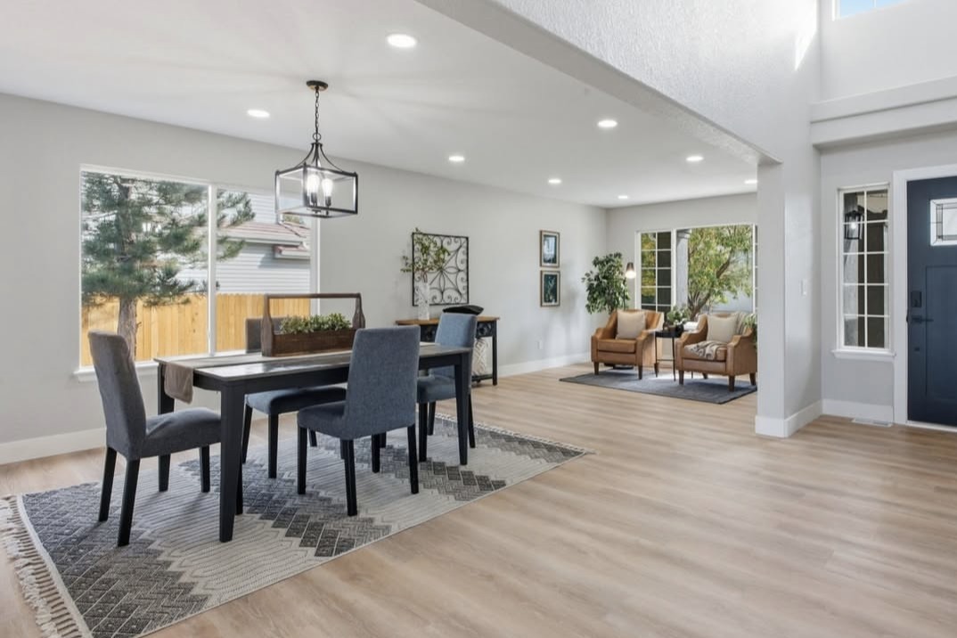 Dining room and entry with a navy front door