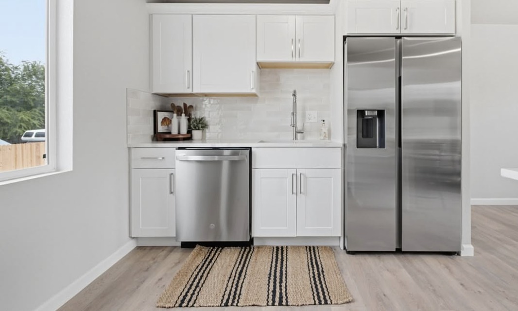 White kitchen with stainless appliances