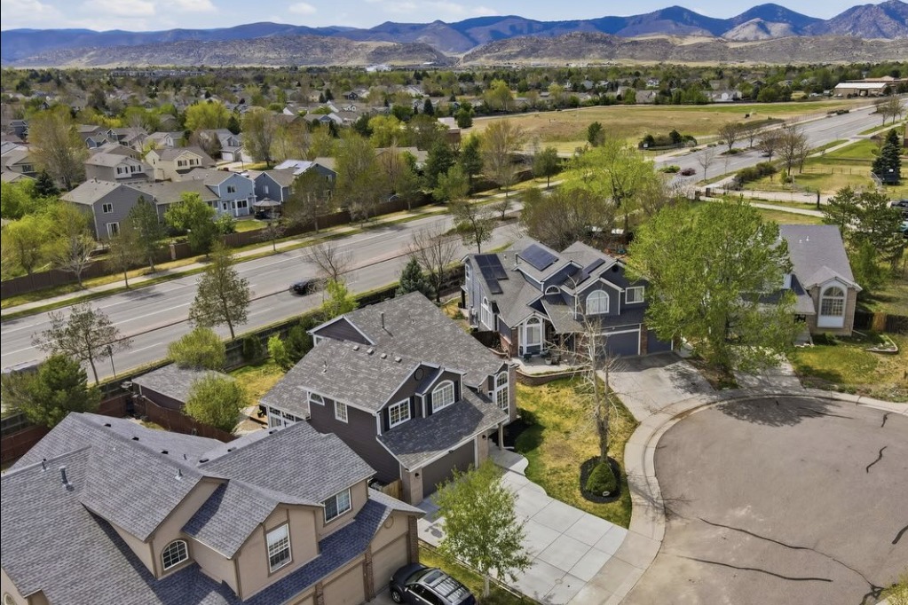 Drone photo of a cul-de-sac home with the foothills behind