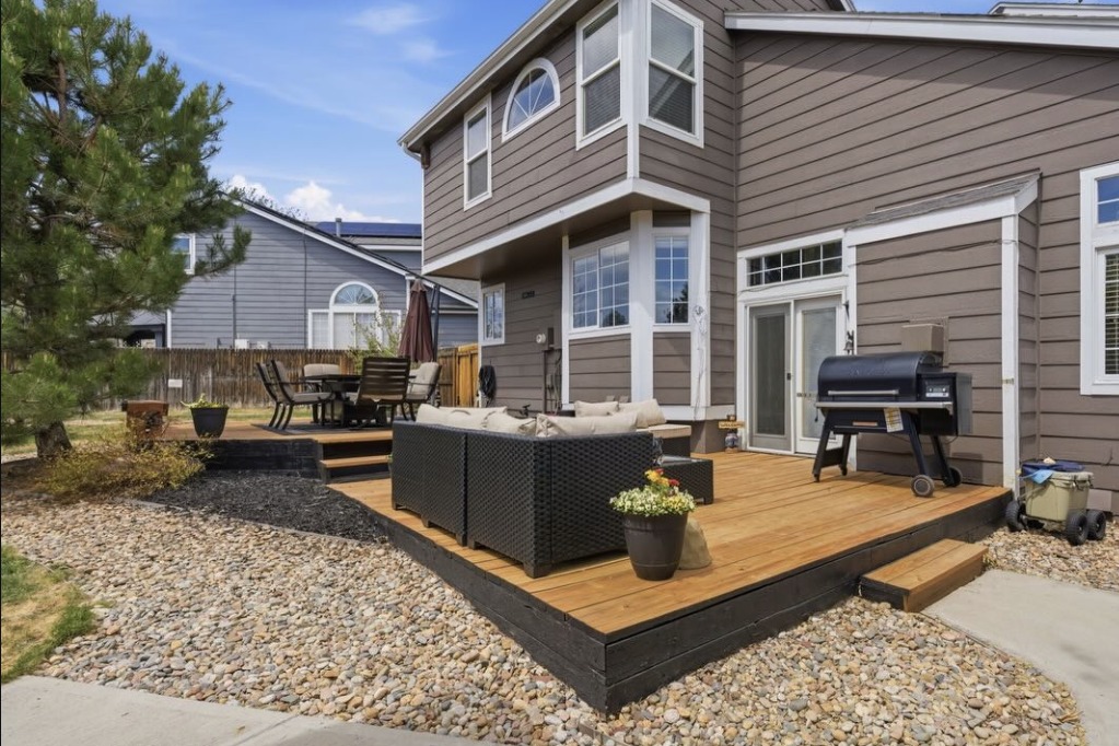 Back deck with outdoor seating and a grill