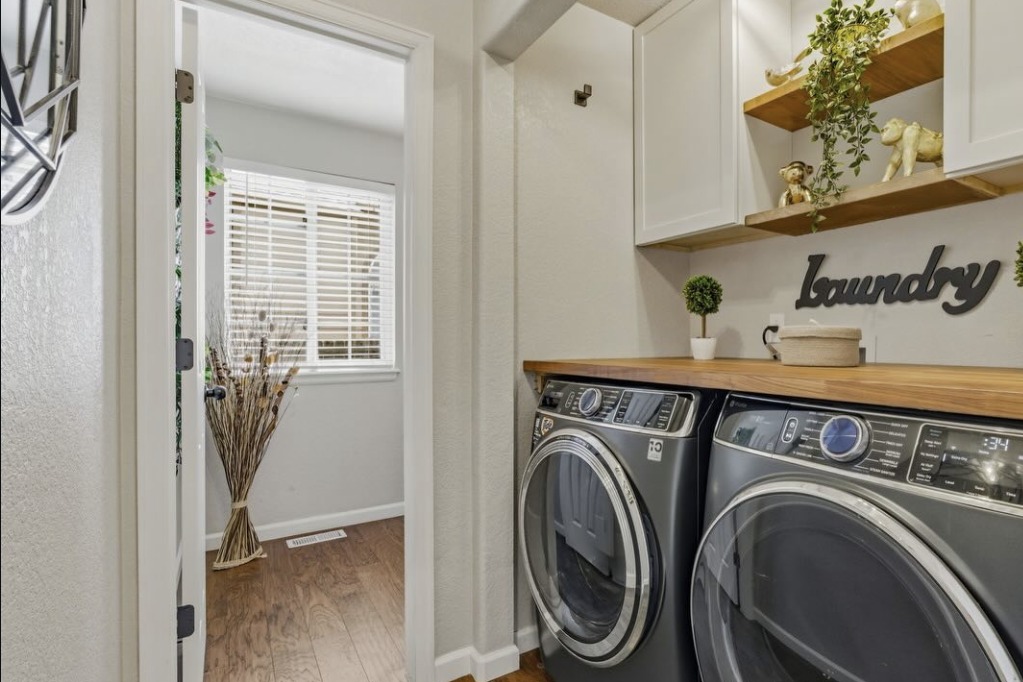Laundry room with wood shelves and front-load machines