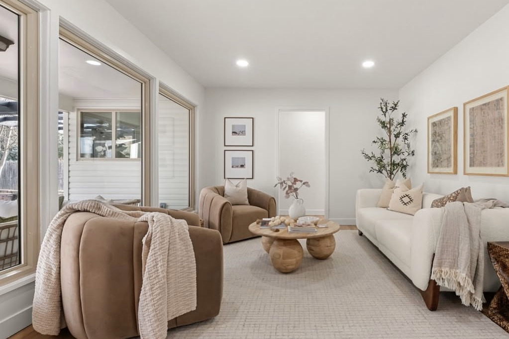 Staged living room with boucle chairs and a sofa