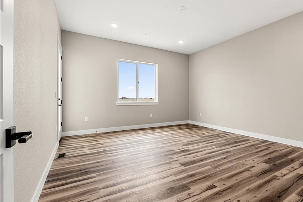 Empty bedroom with wood-look floors