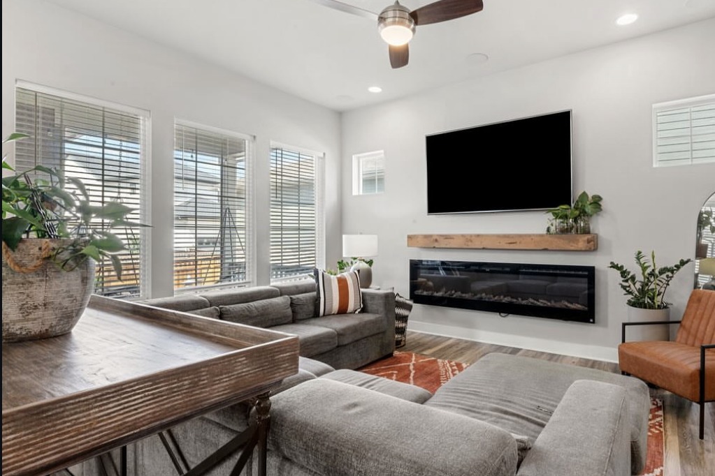 Living room with a linear fireplace and sectional