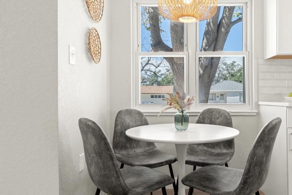 Breakfast nook with a round table and rattan pendant
